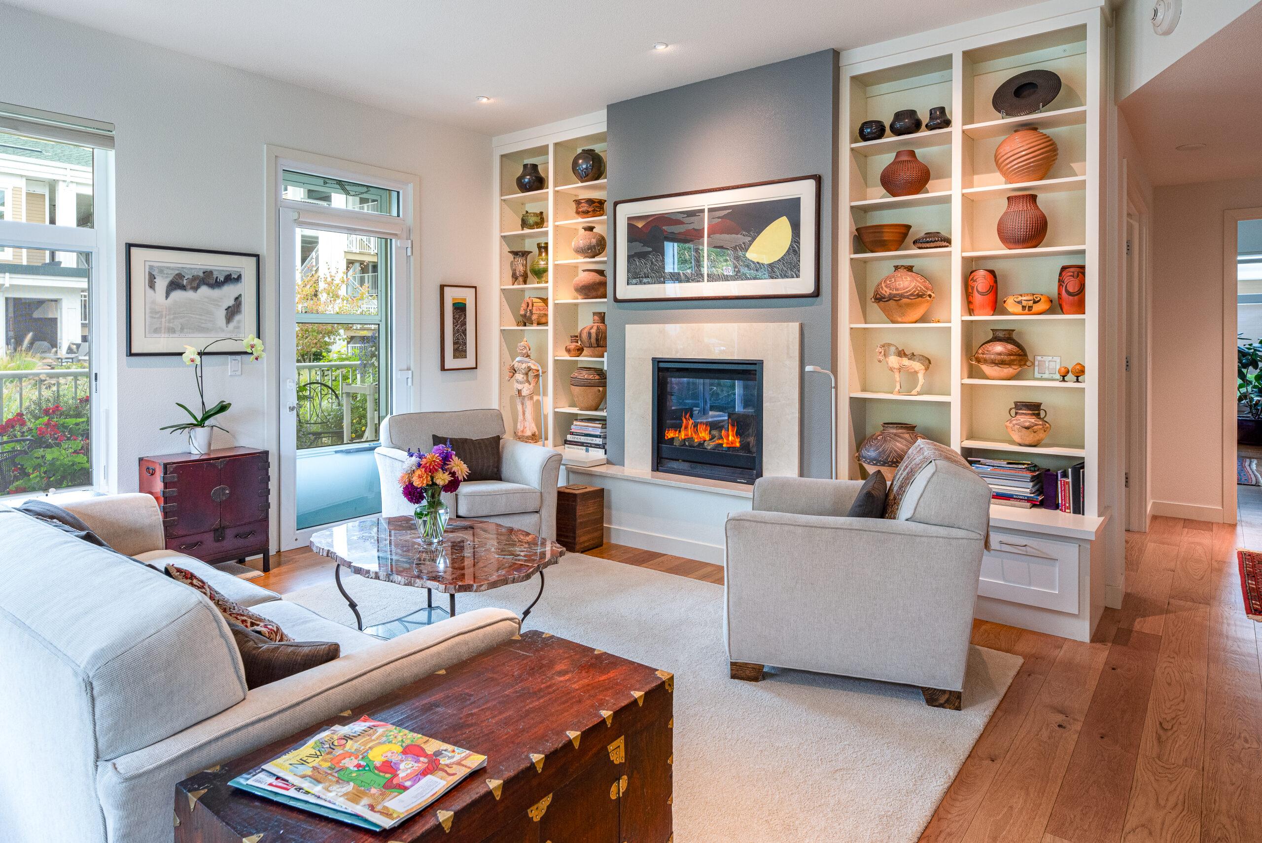 Cascade Manor residence living room with numerous paintings and decorative vases