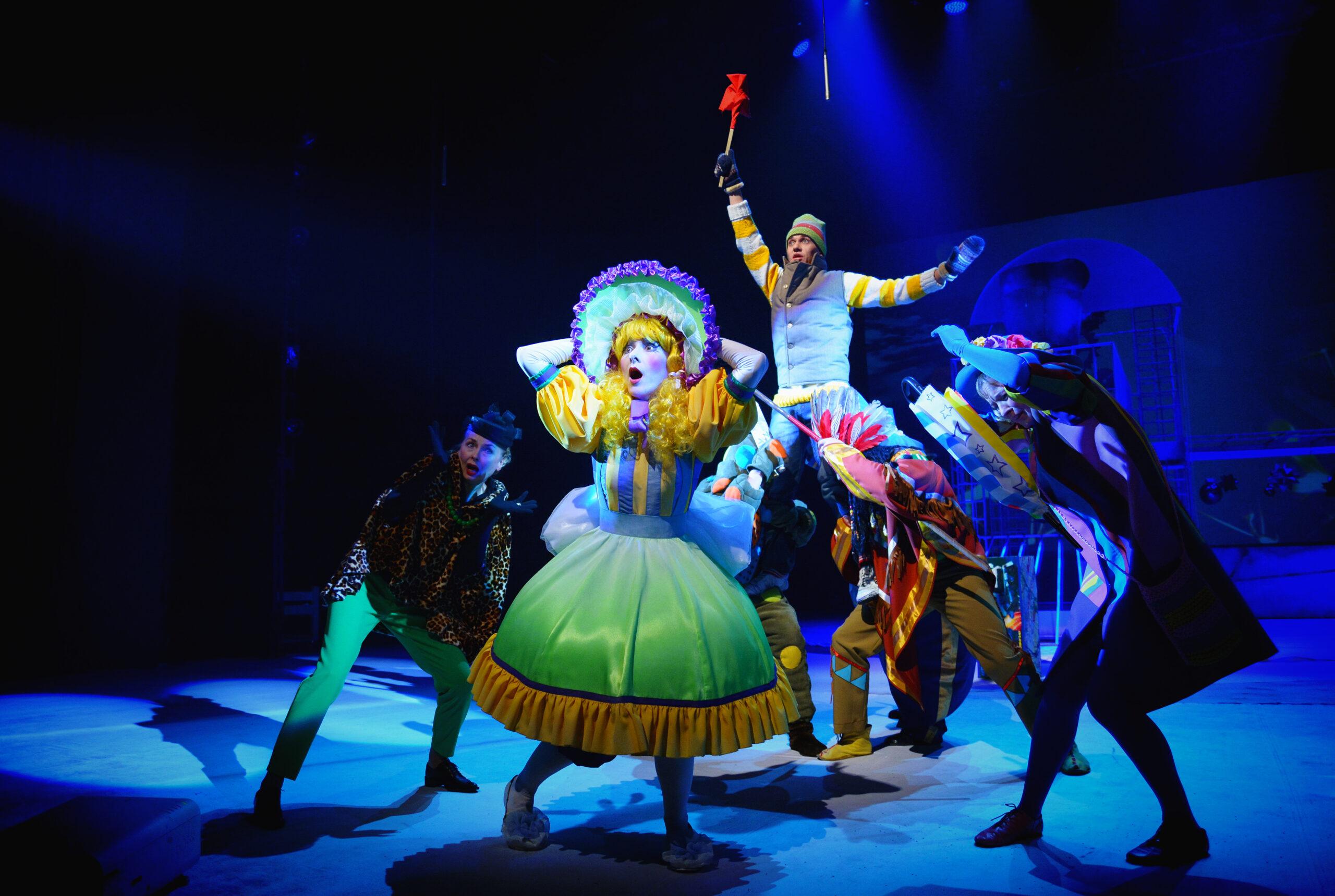 A group of actors stand in elaborate fairy-tale costumes