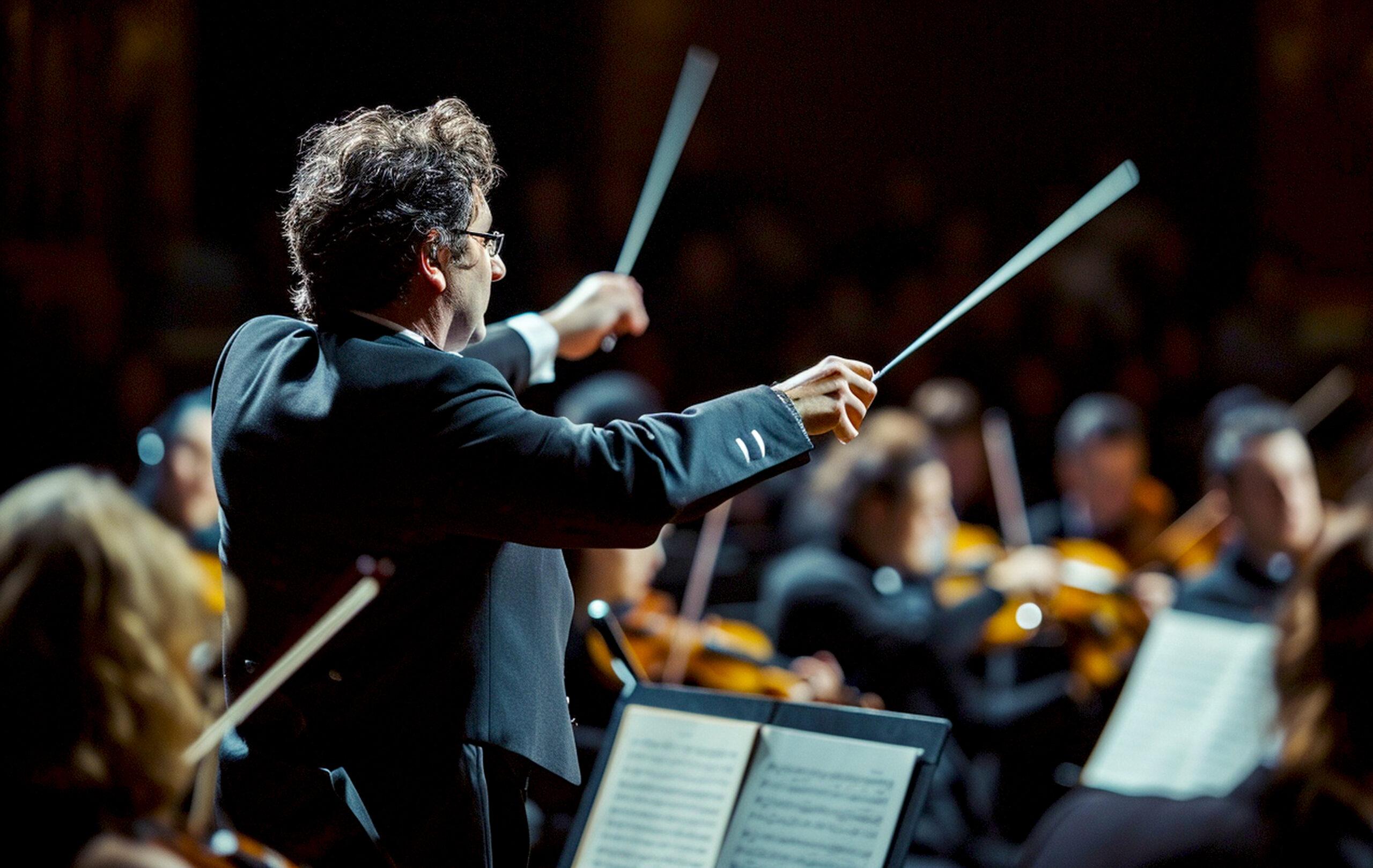 A conductor with two batons leads a chamber orchestra