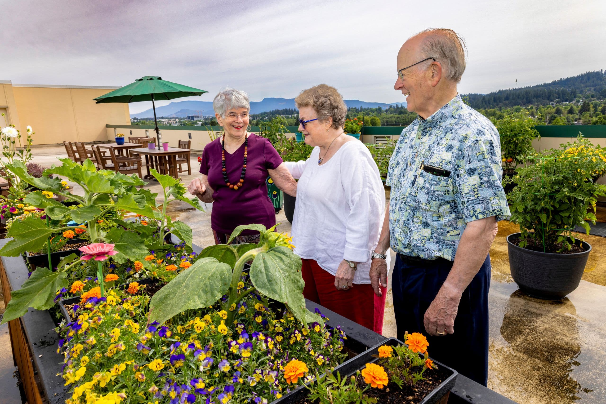Three residents on the patio overlooking the city of Eugene